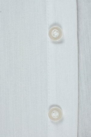 Cotton and polyester fabric clothing, buttons on shirt.の写真素材