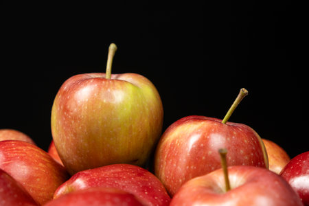 Group of fresh organic red whole apples on a black background.の写真素材