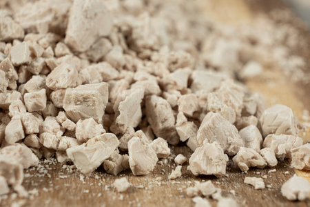 Compressed fresh yeast cubes close-up on a wooden backgroundの写真素材