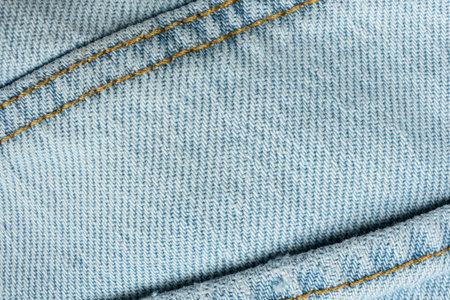 Detailed View of Blue Jeans Fabric and Thread Stitching.