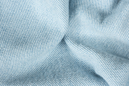 Macro View of Wrinkled Denim Cloth with Shadows and Textureの写真素材