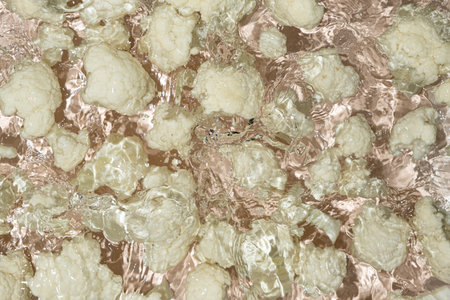 Fresh Cauliflower Dropped in Water with Splash Effect Aboveの写真素材