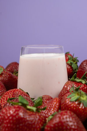 Strawberry yogurt in glasses among fresh, ripe strawberriesの写真素材