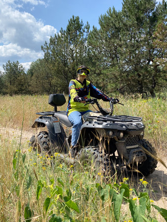 Quad bike ride on dirt roads in nature, vertical shooting.の写真素材