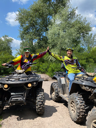 Quad bike ride on dirt roads in nature, vertical shooting.