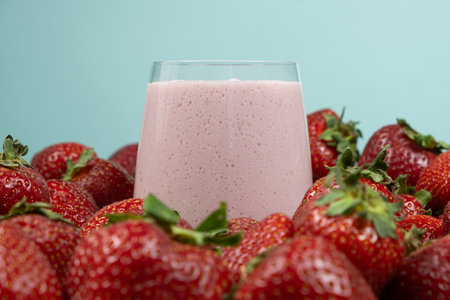 Freshly made strawberry milkshake with milk, ice cream and strawberriesの写真素材
