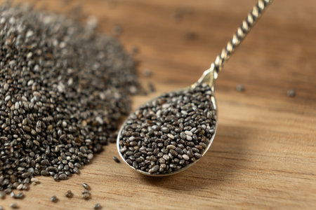 Chia seeds in a spoon on a wooden background, close-upの写真素材