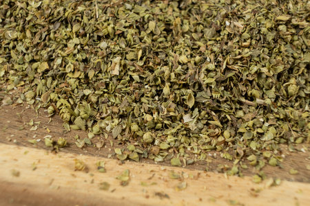 Natural Italian Spice Dried Chopped Oregano on Wooden Macro Backgroundの写真素材