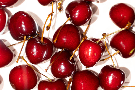 Ripe red sweet cherry in water close-up top viewの写真素材