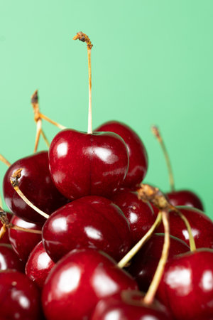 Fresh Sweet Cherries with Vibrant Green Backdropの写真素材