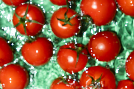Top View of Wet Tomatoes in Fresh Splash Scene.の写真素材