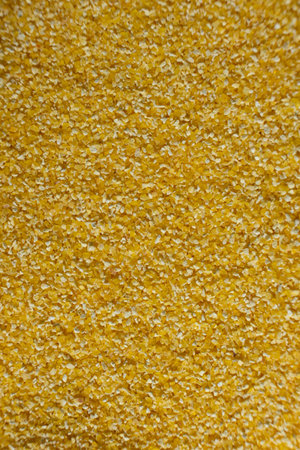 Raw Yellow Corn Grits Close-Up Texture.
