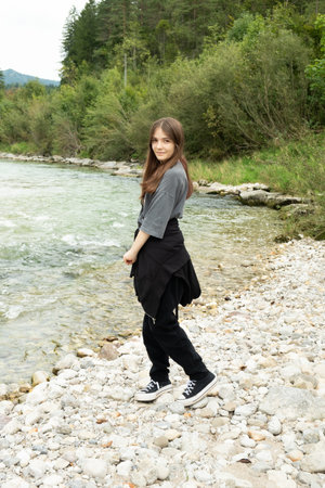 Modern Stylish Teenage Girl Outdoors Near the River.の写真素材