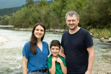 Parents and Child Enjoying Outdoor Walk in Green Natural Landscape.の写真素材