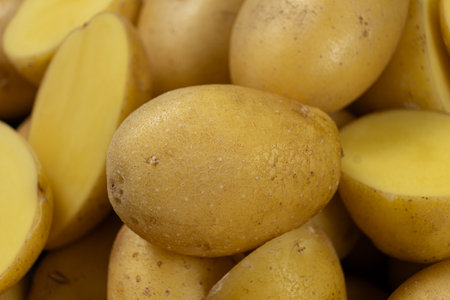 Fresh raw unpeeled potatoes close-up.の写真素材