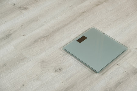 Modern Glass Digital Bathroom Scales. Weight Loss and Health Concept with Copy Space.