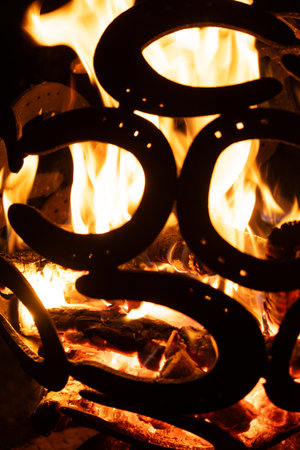 Warm Fire Pit at Night Decorated with Metal Horsehoe Art.の写真素材