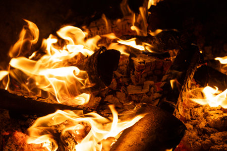 Close-up of Logs Burning with Intense Yellow and Orange Flames.