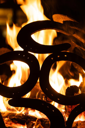 Warm Fire Pit at Night Decorated with Metal Horsehoe Art.の写真素材