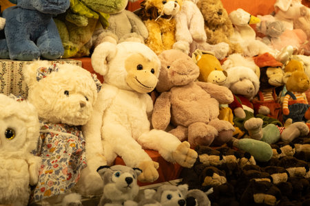 Assorted cute plush toys on a shelf, collection of soft stuffed animals for sale.