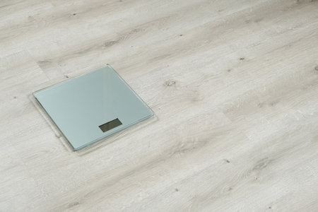 Modern Glass Digital Bathroom Scales. Weight Loss and Health Concept with Copy Spaceの写真素材