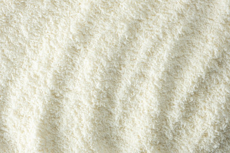 Background texture of white desiccated coconut flakes top view.の写真素材