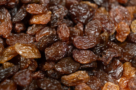 Macro texture of brown raisins, food background