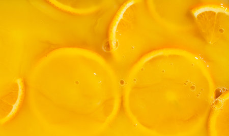 Macro view of orange slices submerged in fresh fruit nectarの写真素材