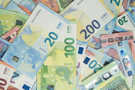 Pile of Euro banknotes of different denominations top view.