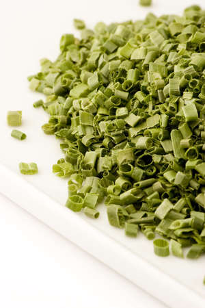 Freeze dried chives on a plate against a white background, Studio shot.の写真素材