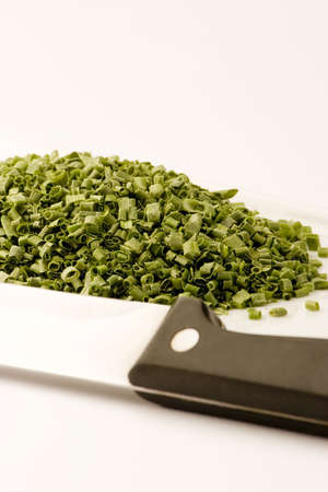 Freeze dried chives on a plate against a white background, Studio shot.の写真素材