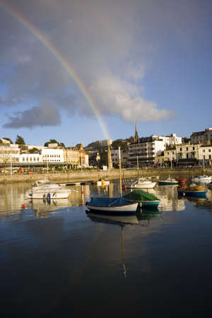 A rainbow over the town of Torquay, Devon.の写真素材