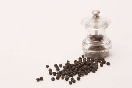Black peppercorns shot against a plain backgroundの写真素材