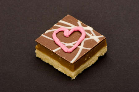 Chocolate cakes with  'love hearts' written in icing.の写真素材