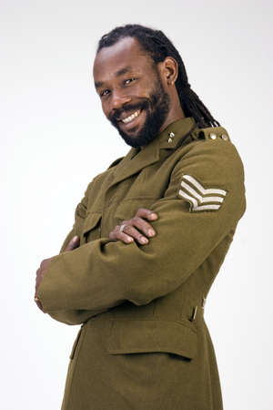 A Black man in a Army jacket isolated on a white background.