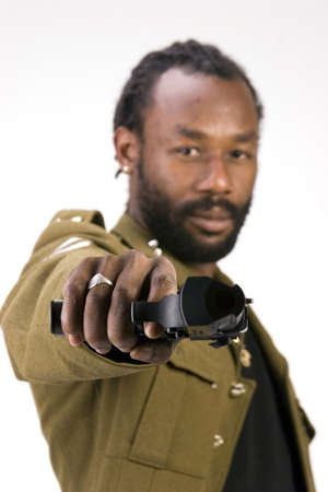 A Black man in a Army jacket with a gun isolated on a white background.の写真素材