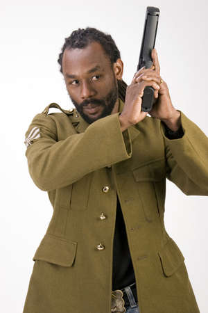 A Black man in a Army jacket with a gun isolated on a white background.の写真素材