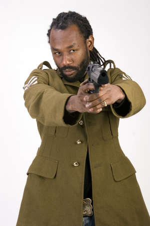 A Black man in a Army jacket with a gun isolated on a white background.の写真素材