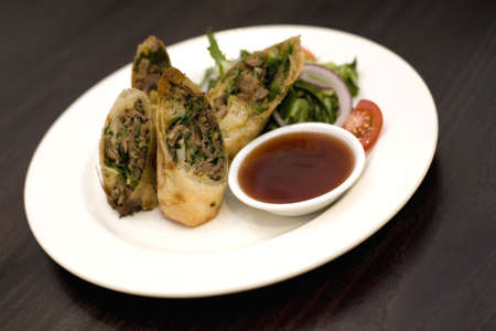 A dish of roasted duck rolls.
