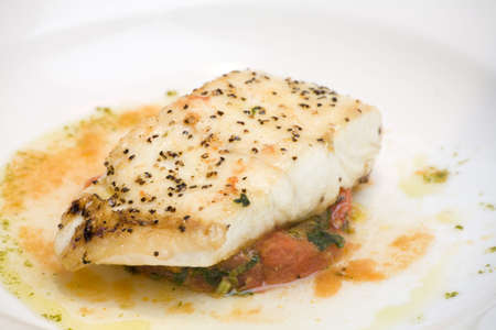 A plate with a Salmon Fillet  and sauce.