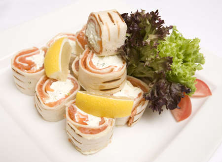 A dish of Salmon and soft cheese wrapsの写真素材