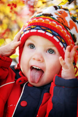 The child is emotionally Hamming out his tongue and holding his headの写真素材