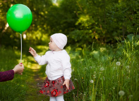 little girl learns a balloon summer in the Parkの写真素材
