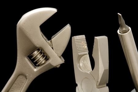 object on black - tool  screwdriver and spanner