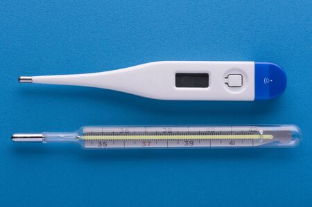 object on blue - medical thermometer close up
