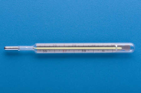 object on blue - medical thermometer close up