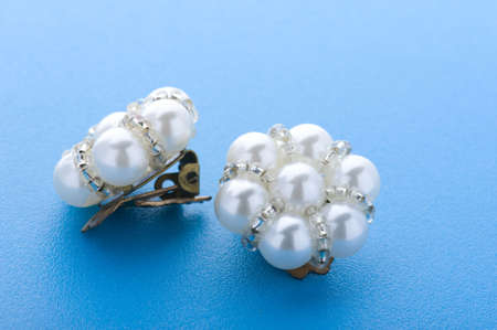 object on blue - costume jewellery earring close upの写真素材