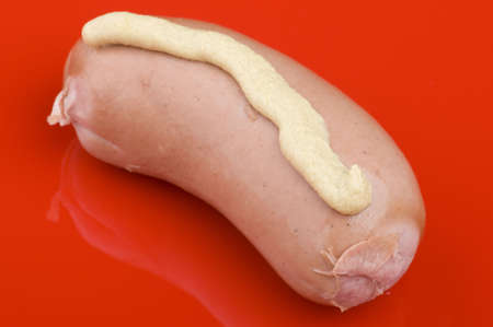 object on red - food sausage with mustardの写真素材