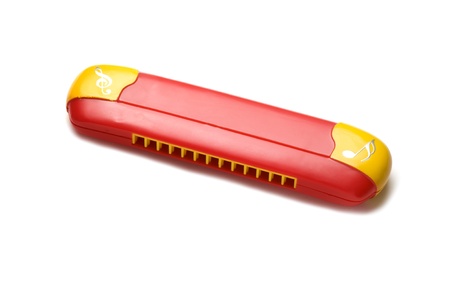object on white - plastic harmonica close up