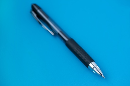 object on blue - pen on blue close upの写真素材